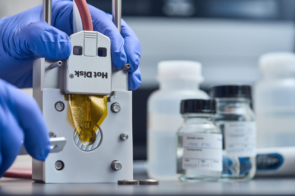 Hot Disk sensor mounted in a sample holder for thermal conductivity measurements of liquids.
